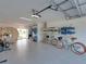Well-organized garage equipped with paddle boards, bicycles, and a sauna at 4215 Saltwater Pearl Way, Cortez, FL 34215