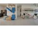 Functional garage featuring storage, paddle boards, bikes, and beach equipment at 4215 Saltwater Pearl Way, Cortez, FL 34215