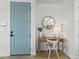 Entryway with a blue door, small desk, a chair, a lamp, and a mirror at 4215 Saltwater Pearl Way, Cortez, FL 34215