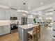 Open concept kitchen with an island, stainless steel appliances, and view of dining and living areas at 4215 Saltwater Pearl Way, Cortez, FL 34215