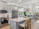 Open-concept kitchen with island seating, stainless appliances, and view to the living room at 4215 Saltwater Pearl Way, Cortez, FL 34215