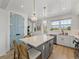 Bright kitchen with a large island, white countertops, and stainless steel appliances at 4215 Saltwater Pearl Way, Cortez, FL 34215