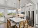 Stylish kitchen featuring white cabinets, stainless steel appliances, and a center island at 4215 Saltwater Pearl Way, Cortez, FL 34215