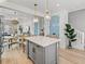Bright kitchen island with seating, pendant lights, and view to the dining and living area at 4215 Saltwater Pearl Way, Cortez, FL 34215