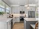 Modern kitchen with white cabinets, stainless steel appliances, and quartz countertops at 4215 Saltwater Pearl Way, Cortez, FL 34215