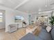 Bright and airy living room with a large television, cozy seating, and open layout to the kitchen at 4215 Saltwater Pearl Way, Cortez, FL 34215