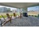 Inviting covered patio with brick pavers, complete with a shower and comfortable seating area at 4215 Saltwater Pearl Way, Cortez, FL 34215