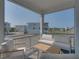 Comfortable screened-in porch with plush white sofas and scenic neighborhood views at 4215 Saltwater Pearl Way, Cortez, FL 34215
