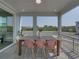 Relaxing screened patio featuring an outdoor dining table and peaceful neighborhood views at 4215 Saltwater Pearl Way, Cortez, FL 34215