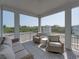 Relax on this screened porch with comfortable seating and views of the surrounding natural landscape at 4215 Saltwater Pearl Way, Cortez, FL 34215