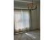 Bedroom with neutral tones, large window, and chandelier lighting at 607 Manchester Woods Dr # 84, Sun City Center, FL 33573