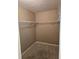 Walk-in closet with wall-mounted white wire shelving at 607 Manchester Woods Dr # 84, Sun City Center, FL 33573
