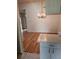 Dining room with wood floors, chandelier and view of the kitchen at 607 Manchester Woods Dr # 84, Sun City Center, FL 33573
