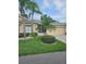 Inviting one-story home with lush landscaping and a well-manicured lawn at 607 Manchester Woods Dr # 84, Sun City Center, FL 33573