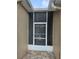 Close-up of a screened-in front entryway with a decorative security door at 607 Manchester Woods Dr # 84, Sun City Center, FL 33573