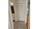 Hallway with view into the bathroom and closet space at 607 Manchester Woods Dr # 84, Sun City Center, FL 33573