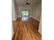 Bright living room featuring hardwood floors, high ceilings, and sliding glass doors at 607 Manchester Woods Dr # 84, Sun City Center, FL 33573