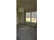 Spacious living room with large window and modern chandelier lighting fixture at 607 Manchester Woods Dr # 84, Sun City Center, FL 33573