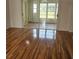 Spacious living room featuring hardwood floors and sliding glass doors at 607 Manchester Woods Dr # 84, Sun City Center, FL 33573