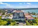 Stunning aerial view of building near waterfront shows lush landscaping, pool, and ample parking at 6357 Bahia Del Mar Blvd # 403, St Petersburg, FL 33715