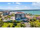 Gorgeous aerial shot showcases waterfront buildings, palm trees, manicured lawns, and pool area at 6357 Bahia Del Mar Blvd # 403, St Petersburg, FL 33715