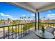 Balcony with views of lush landscaping, a lake, and nearby buildings under a sunny sky at 6357 Bahia Del Mar Blvd # 403, St Petersburg, FL 33715