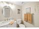 A bathroom vanity with a marble countertop and a round mirror hangs on the wall at 6357 Bahia Del Mar Blvd # 403, St Petersburg, FL 33715