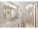 Bright bathroom featuring a walk-in shower with custom vanity and ample lighting at 6357 Bahia Del Mar Blvd # 403, St Petersburg, FL 33715