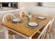 The dining area has a wooden table with white chairs and place settings at 6357 Bahia Del Mar Blvd # 403, St Petersburg, FL 33715
