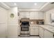 Cozy kitchen features stainless steel appliances, tile backsplash, and white cabinetry at 6357 Bahia Del Mar Blvd # 403, St Petersburg, FL 33715