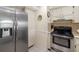 Kitchen with stainless steel fridge and appliances features cream cabinets at 6357 Bahia Del Mar Blvd # 403, St Petersburg, FL 33715