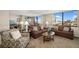 Bright living room with comfortable seating, mirrored wall, and expansive windows with beautiful views at 6357 Bahia Del Mar Blvd # 403, St Petersburg, FL 33715