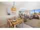 Living/dining room view with table, pendant lighting, and water view at 6357 Bahia Del Mar Blvd # 403, St Petersburg, FL 33715