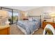 Cozy bedroom featuring a large bed with balcony access, and water view at 6357 Bahia Del Mar Blvd # 403, St Petersburg, FL 33715