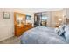 Comfortable bedroom with balcony access, dresser, and tv for entertainment at 6357 Bahia Del Mar Blvd # 403, St Petersburg, FL 33715