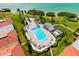 Aerial view of a community pool surrounded by palm trees, lounge chairs, and manicured landscaping at 6357 Bahia Del Mar Blvd # 403, St Petersburg, FL 33715