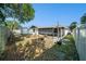 Large backyard featuring a storage shed and covered patio area at 7136 Isle Dr, Port Richey, FL 34668
