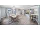 Light and airy dining space with contemporary furnishings, wood floors, and seamless transition to the kitchen at 7136 Isle Dr, Port Richey, FL 34668