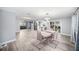 Bright dining area featuring a modern table set, unique lighting, and an open flow to the living spaces at 7136 Isle Dr, Port Richey, FL 34668