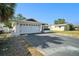 View of a house displaying a two-car garage with a spacious driveway and a well-maintained front exterior at 7136 Isle Dr, Port Richey, FL 34668