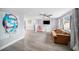 Spacious living room with luxury vinyl flooring and large picture window at 7136 Isle Dr, Port Richey, FL 34668