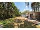 Large backyard with mature trees, shed, and patio at 7339 Royal Palm Dr, New Port Richey, FL 34652