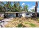 Charming single-story home with a well-maintained front yard and mature trees at 7339 Royal Palm Dr, New Port Richey, FL 34652