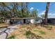 Charming single-story home with a well-maintained front yard and mature trees at 7339 Royal Palm Dr, New Port Richey, FL 34652