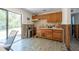 The kitchen features oak cabinets and a view to the back yard at 7339 Royal Palm Dr, New Port Richey, FL 34652