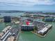 An aerial shot highlights the building's location near the water, tennis courts, and docking facilities at 7700 Sun Island S Dr # 107, South Pasadena, FL 33707