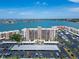 Aerial view of the condo building, covered parking area, and ocean views at 7700 Sun Island S Dr # 107, South Pasadena, FL 33707