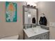 Bathroom with a stylish vanity, sink, and a vibrant mermaid art piece at 7700 Sun Island S Dr # 107, South Pasadena, FL 33707