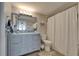 Well-lit bathroom featuring a vanity with ample storage and a shower with decorative tiling at 7700 Sun Island S Dr # 107, South Pasadena, FL 33707