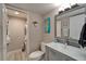 Neutral-toned bathroom featuring vanity with storage, modern faucet, and stacked laundry closet at 7700 Sun Island S Dr # 107, South Pasadena, FL 33707